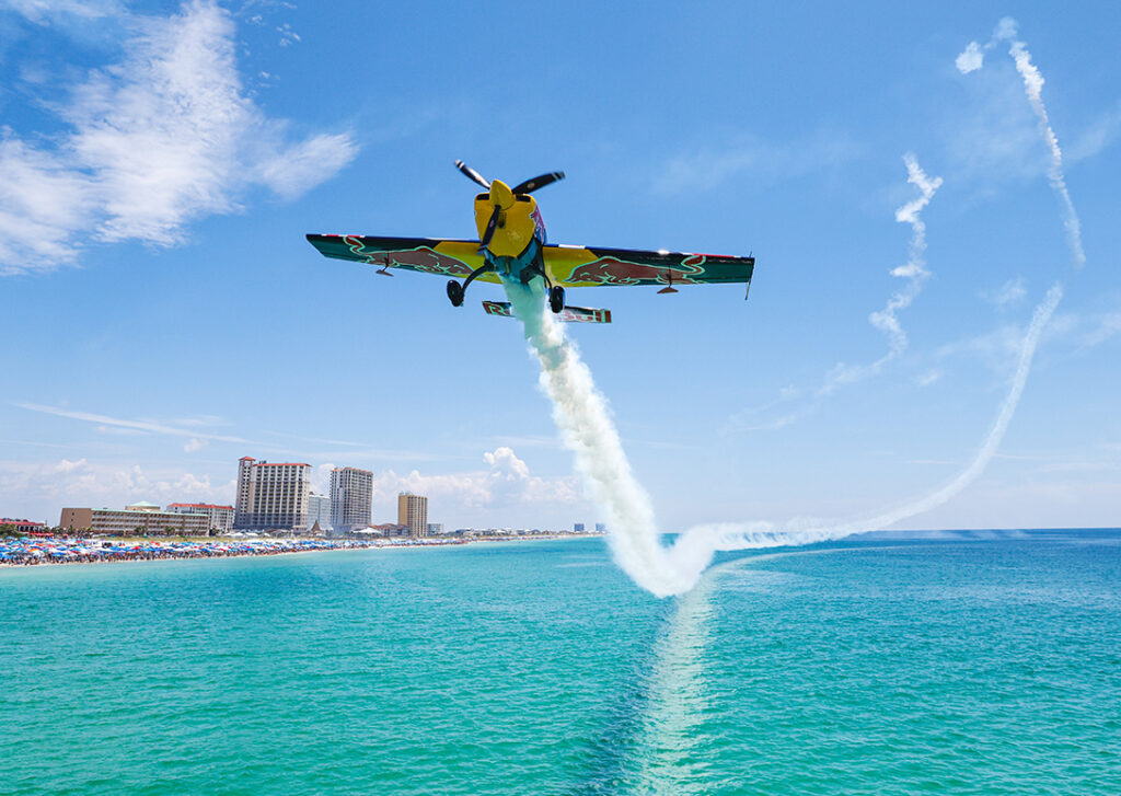 Plane flying over the water at Pensacola Beach.