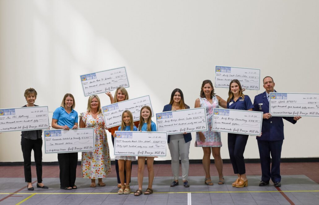2024 Gulf Breeze Will Do grant recipients holding large checks.
