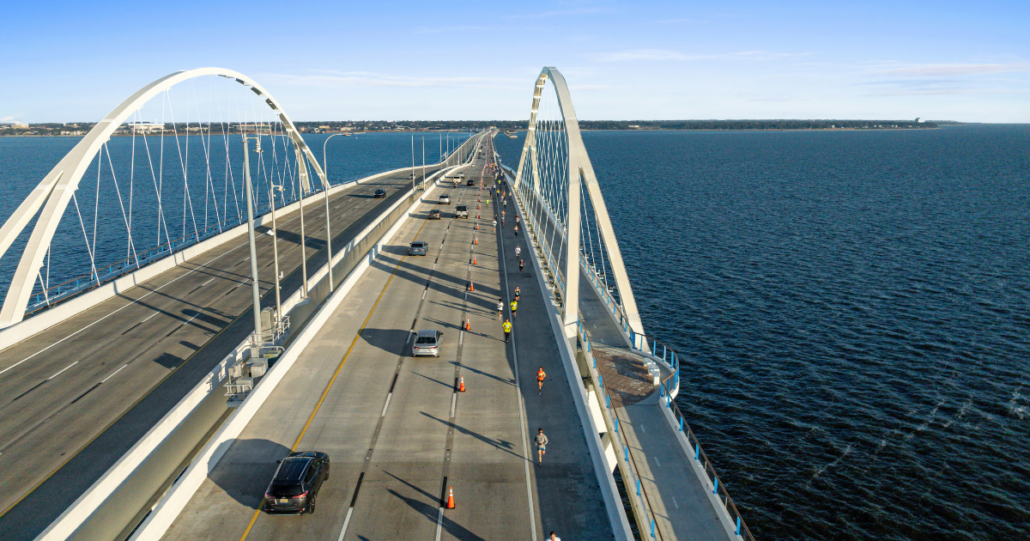 A drone photo of the Pensacola Bridge with Runners from the Pensacola Sports Double Bridge Run