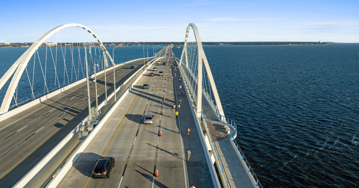 A drone photo of the Pensacola Bridge with Runners from the Pensacola Sports Double Bridge Run