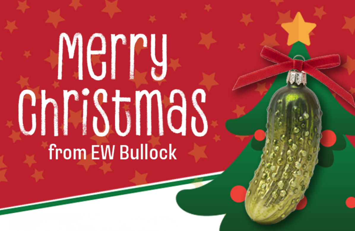 Merry Christmas from EW Bullock with an image of a pickle ornament on a gree.