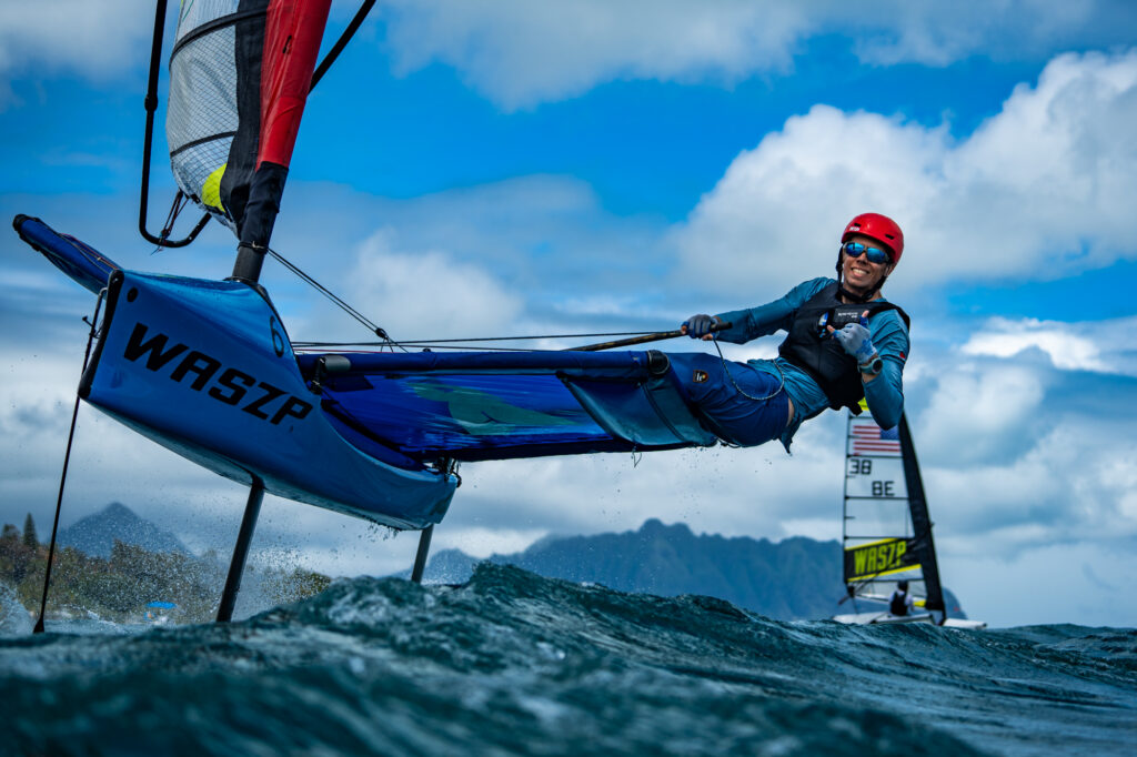 Man on WASZP boat looking at camera and making a hang loose sign with his hand