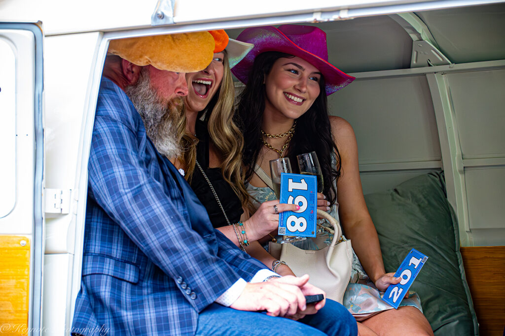 Three people inside a photo booth