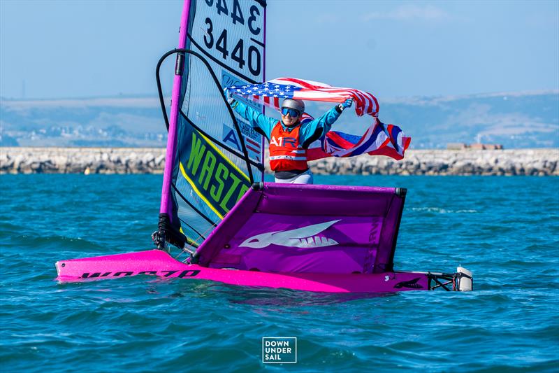 Pearl Lattanzi on a pink WASZP boat holding an American flag
