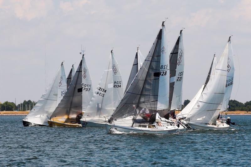 A group of Catalina 22 boats sailing on the water in Pensacola Bay.